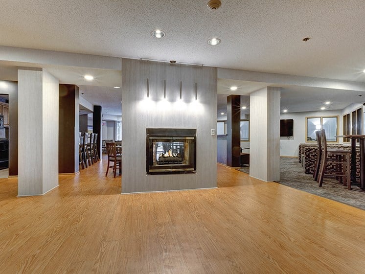 Community room with large hardwood floor and a fireplace